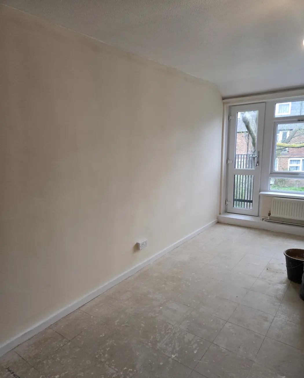 Finished, painted room with light from the balcony doors