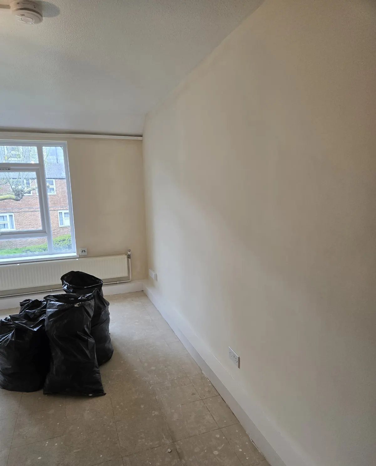 An empty flat room with new plaster and skirting, ready for decorating